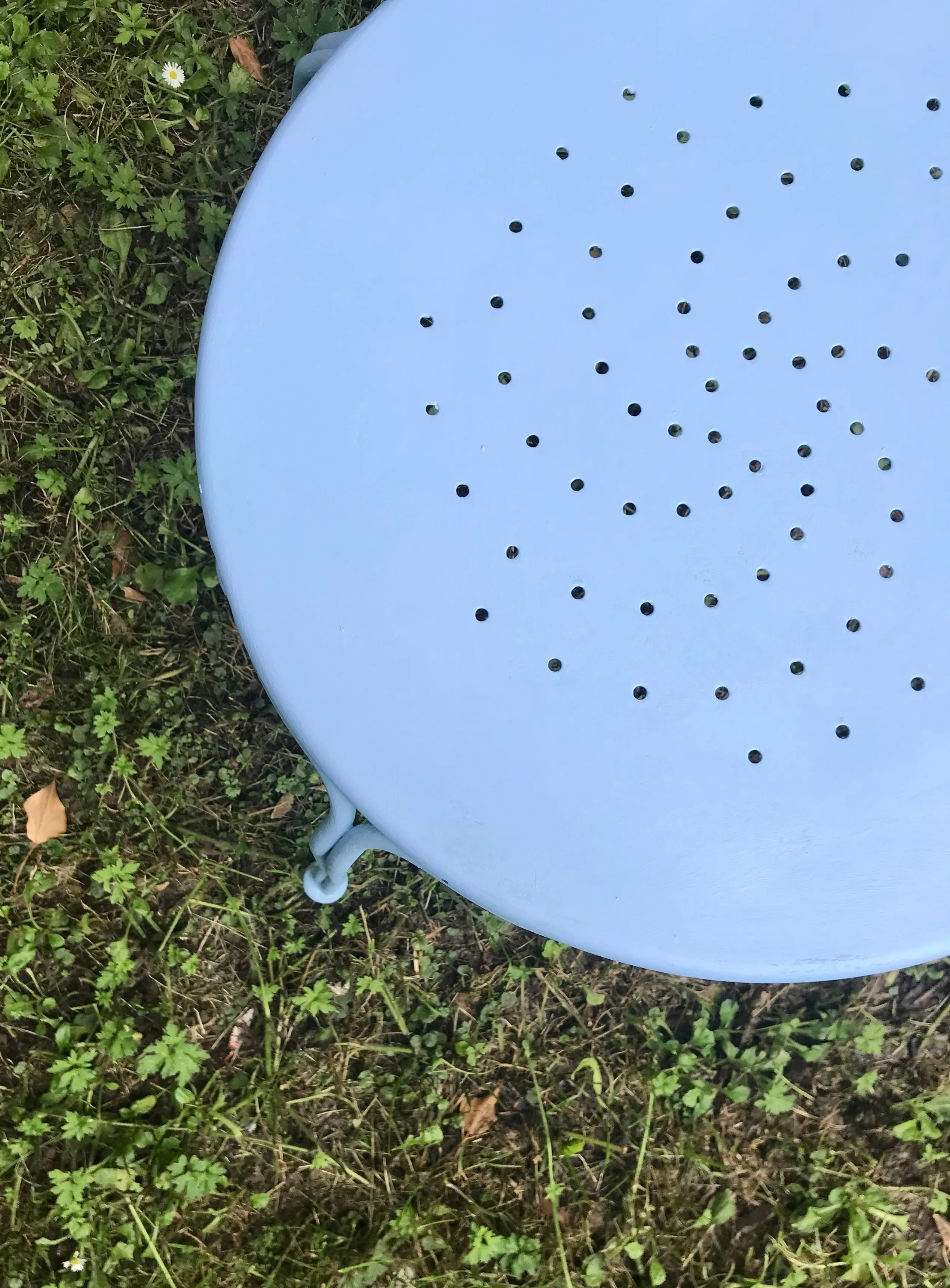 Ornate metal chair painted in pale roundel blue